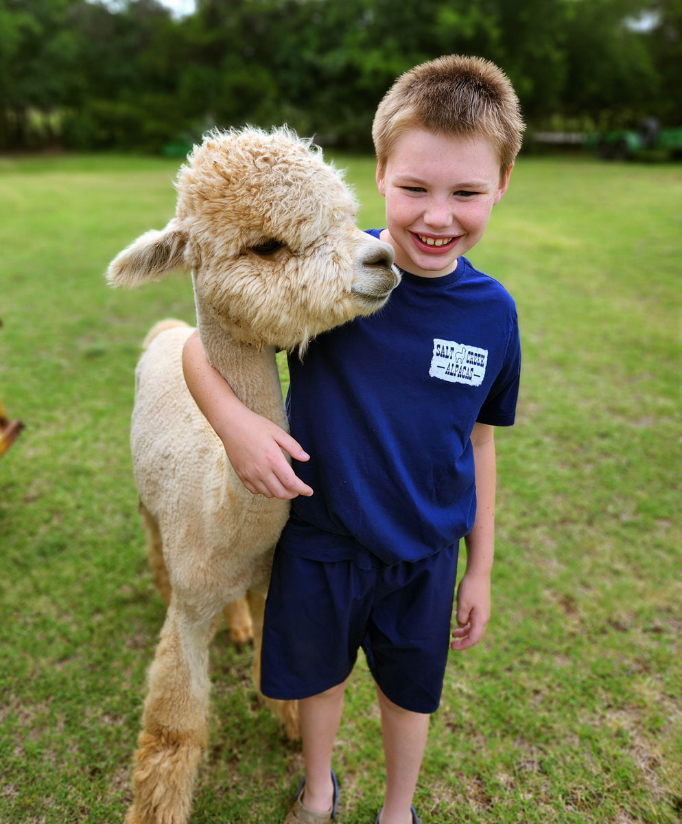 Logan with the alpaca Persistence in field